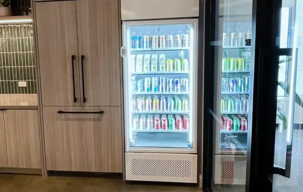 Convene smart coolers integrated seamlessly in modern office pantry with FUEL UP branding